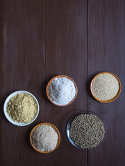 Various superfoods in small bowl on the  brown wood table.