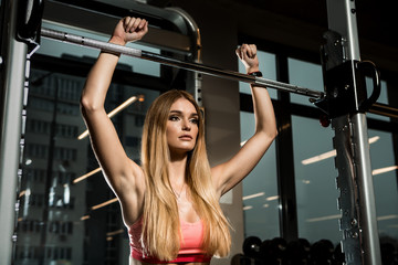 Fototapeta na wymiar Portrait of sporty brutal athletic young female in fashion sportswear doing functional exercise with heavy barbell. Urban style healthy girl lifestyle and sport concept. Yoga fitness workout at gym.