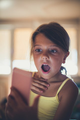 Shocked little  girl with phone.