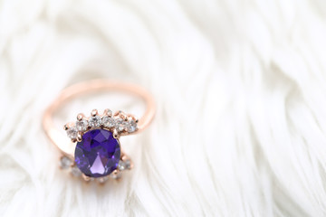 Purple gem stone on gold ring