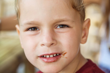 boy eating pancake with banana and chocolate