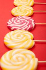 Bright candy on a red background. Lollipops. Handmade.