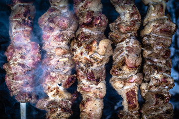 Grilled kebab cooking on metal skewers (grill).