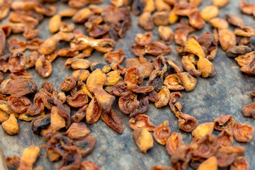 Homemade dried apricots. A leaf with halves of apricots