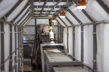 the protective shelter of the tarpaulin arch