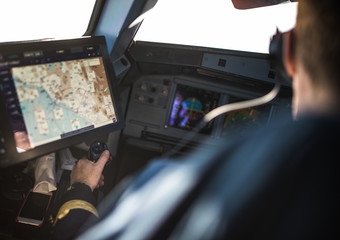 Pilot's hand accelerating on the throttle in  a commercial airliner airplane flight cockpit during takeoff