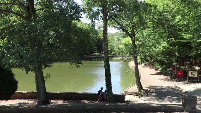 Two hikers walk along a lake in Marcinelle, Belgium