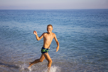 teenager running on the seashore.joy, fun, emotions.Summer vacation,