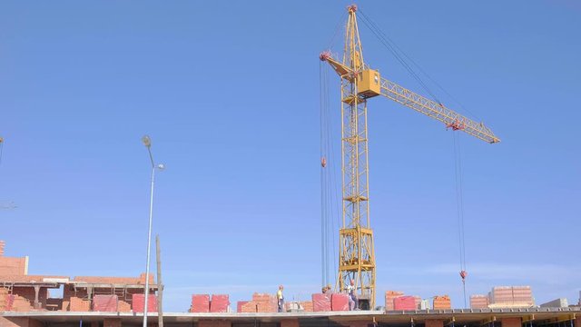 Building construction, work of people and crane