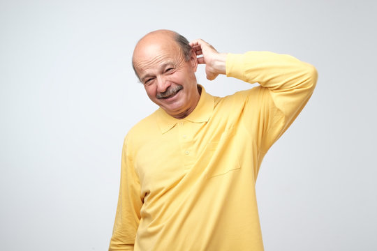 Not sure. Mature adult in yellow tshirt havinga doubt.
