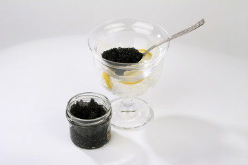Caviar with spoon and lemon isolated on white