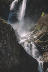mountain waterfall and green forest in the morning light