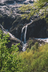 mountain waterfall and green forest in the morning light