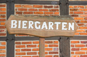 German beer garden sign in front of a half-timbered wall