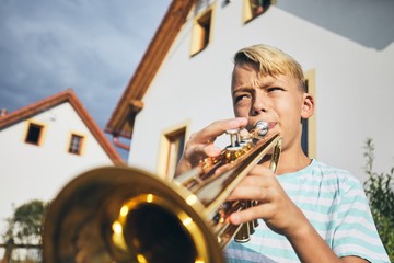 Little boy playing the trumpet