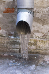 Naklejka na ściany i meble The frozen water from the drainage pipe