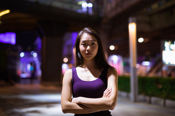 Fototapeta premium Portrait Of Beautiful Asian Woman Outdoors At Night