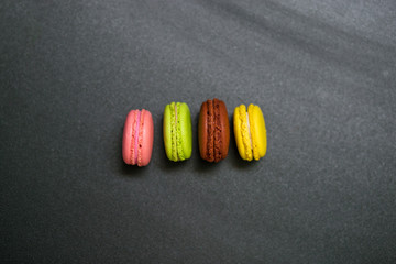Top view of sweet colorful macarons isolated on black background
