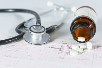stethoscope, pills, vials in medical room on blue background top view mockup