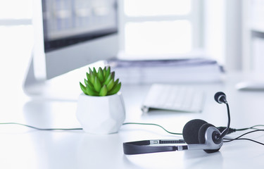 Communication support, call center and customer service help desk. VOIP headset on laptop computer keyboard