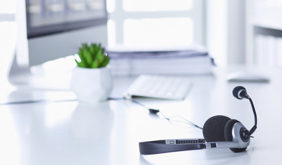Communication support, call center and customer service help desk. VOIP headset on laptop computer keyboard