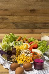 Salads ,eggs and milk placed on wooden table