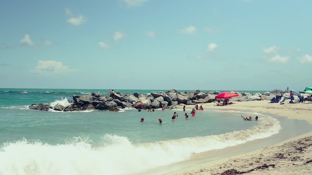 Haulover Beach jetty with people in the water.