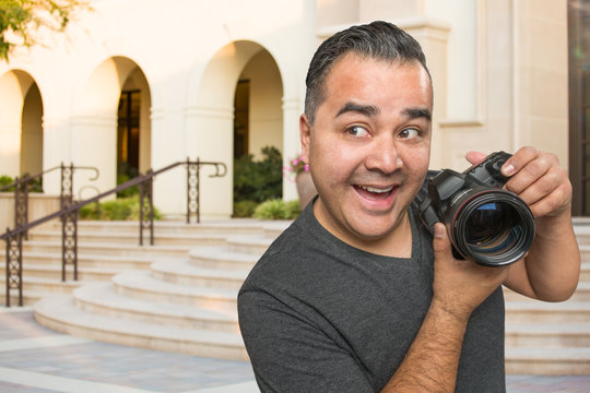 Hispanic Young Male Photographer With DSLR Camera Outdoors