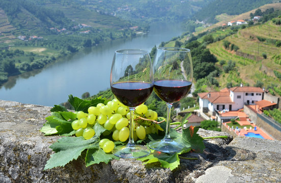 Wine Glasses Against Vineyards In Douro Valley, Portugal