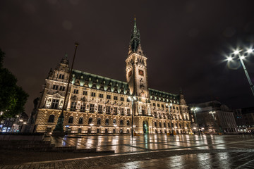 Hamburg City Hall is the seat of local government of the Free and Hanseatic City of Hamburg, Germany. Amazing reflections on the ground. Wet nasty weather.