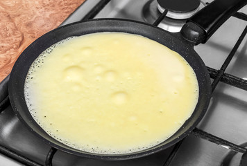 Pancake frying on the pan.