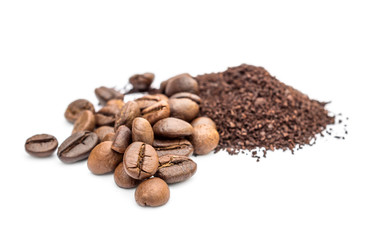 Pile of ground coffee and coffee beans on white.
