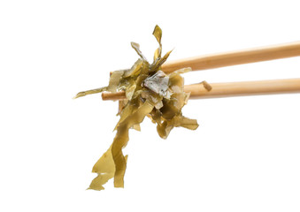 Seaweed on chopsticks isolated on white. Close up.