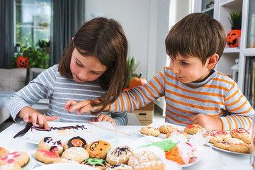 Children glazing cookies for Halloween celebration