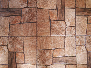 Textured background. Ceramic tiles, stylized as an old cobblestone pavement. Light brown and dark brown tones.