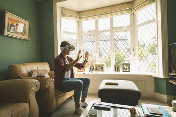 Man using virtual reality headset in living room