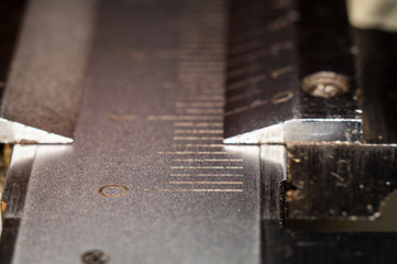 Measuring toolsSlide calipers, numbers and scale of division on a measuring instrument, close-up.