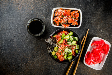 Asian trendy food, sushi poke bowl with cucumber, salmon, avocado, Black and White Sesame Seeds