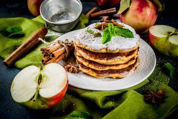 Sweet and spicy autumn apple pancakes, with anise, cinnamon and sugar, dark blue background copy space
