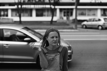 Fototapeta na wymiar street photo in the style of an old black and white film with grain - portrait of a woman in a busy city