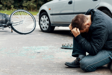 Fototapeta na wymiar Irresponsible car driver after dangerous incident on the road with cyclist