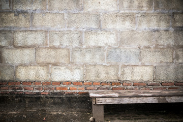 wooden bench and old brick wall