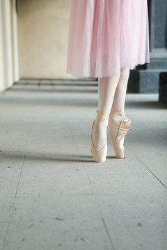 Ballet dancers dancing on street. Young ballerinas in color tutus. Ballet feet on the point