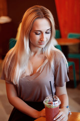 Beautiful Young Woman with Fruit smoothie