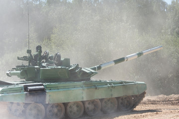 Military or army tank ready to attack and moving over a deserted battle field terrain. a lot of...