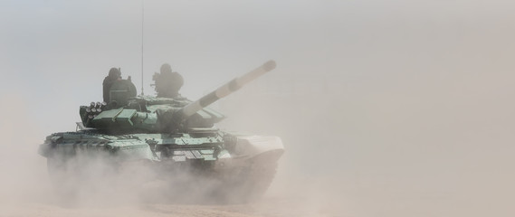 Military or army tank ready to attack and moving over a deserted battle field terrain. a lot of dust. copyspace - 217322166