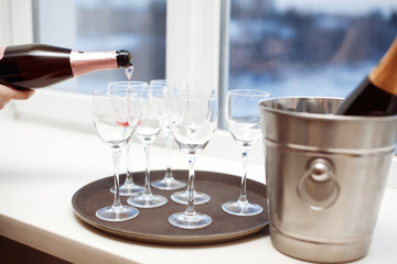 Rose champagne in wineglasses. Champagne is poured into glasses
