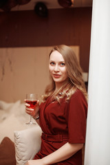 Attractive blond woman with a glass of red wine