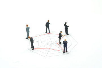 Miniature people businessmen standing on a Circle graphs of various skill levels. The concept used in selecting personnel to participate in the organization. with copy space.