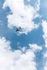 Fototapeta na wymiar airplane flying in blue cloudy sky during daytime